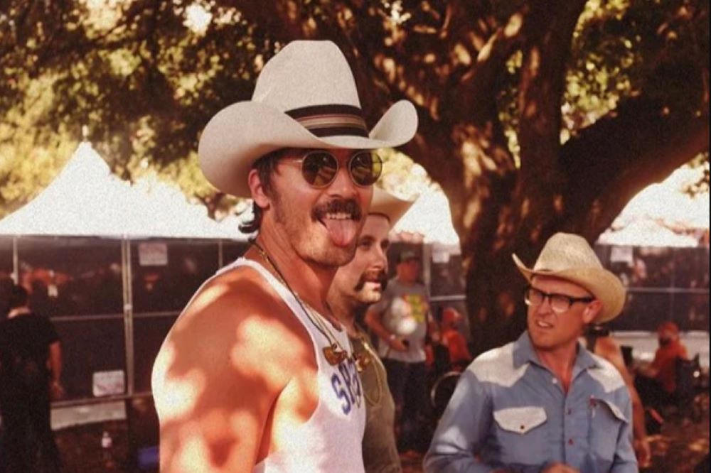 Mark Wystrach with his tongue out, cowboy hat, and Hampton sunglasses