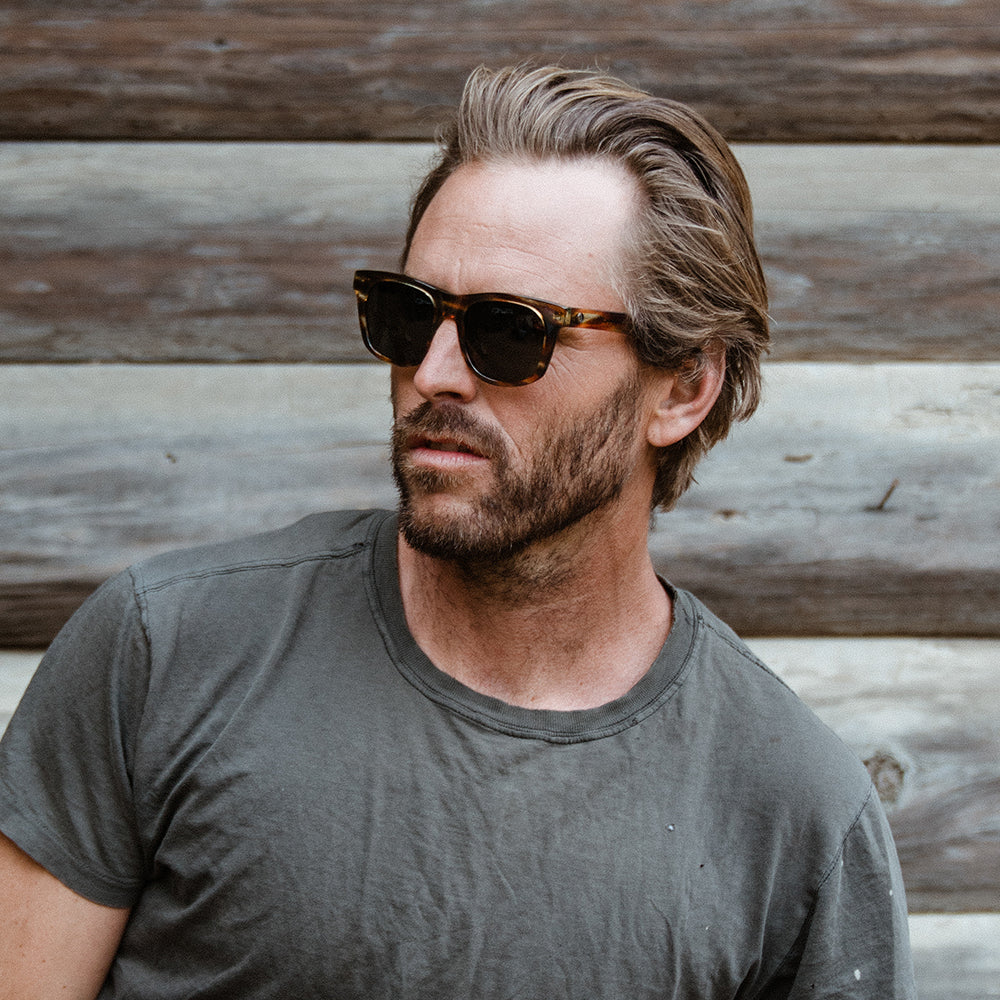 Man wearing tobacco colored Modena sunglass. Classic unisex shape with polarized lenses